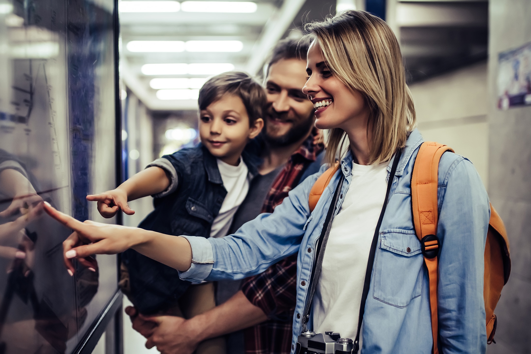 Family of tourists interacting with digital transit map